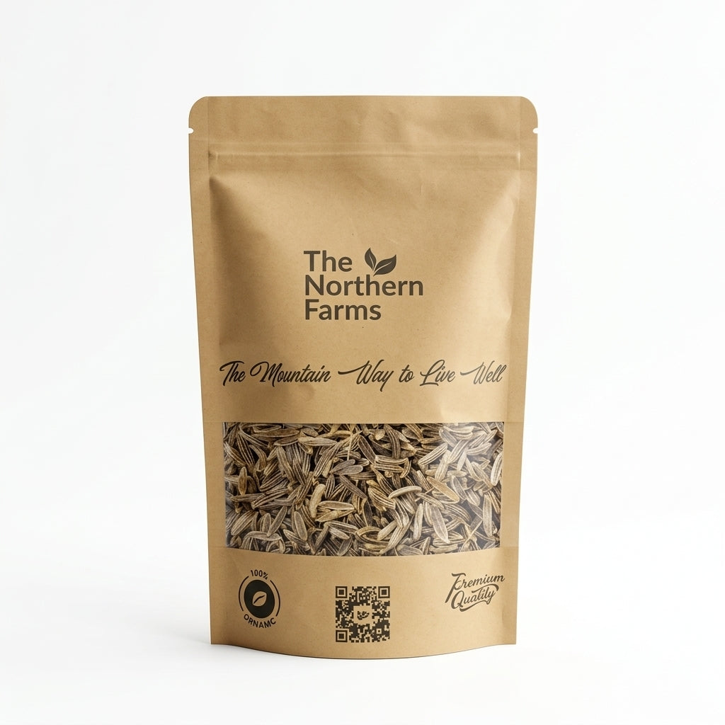 A stand-up kraft paper pouch of black zeera (black cumin) from The Northern Farms, featuring a clear window displaying the black cumin inside, set against a plain white background.