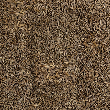 A close-up, top-down view of densely packed black cumin seeds (Chitrali zeera) filling the entire frame.