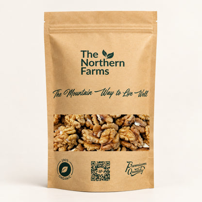 A stand-up kraft paper pouch of walnuts from The Northern Farms, featuring a clear window showing the walnuts inside, on a clean off-white background.