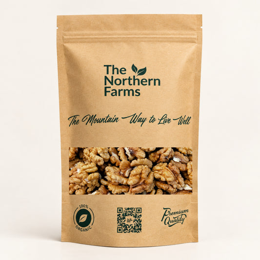 A stand-up kraft paper pouch of walnuts from The Northern Farms, featuring a clear window showing the walnuts inside, on a clean off-white background.