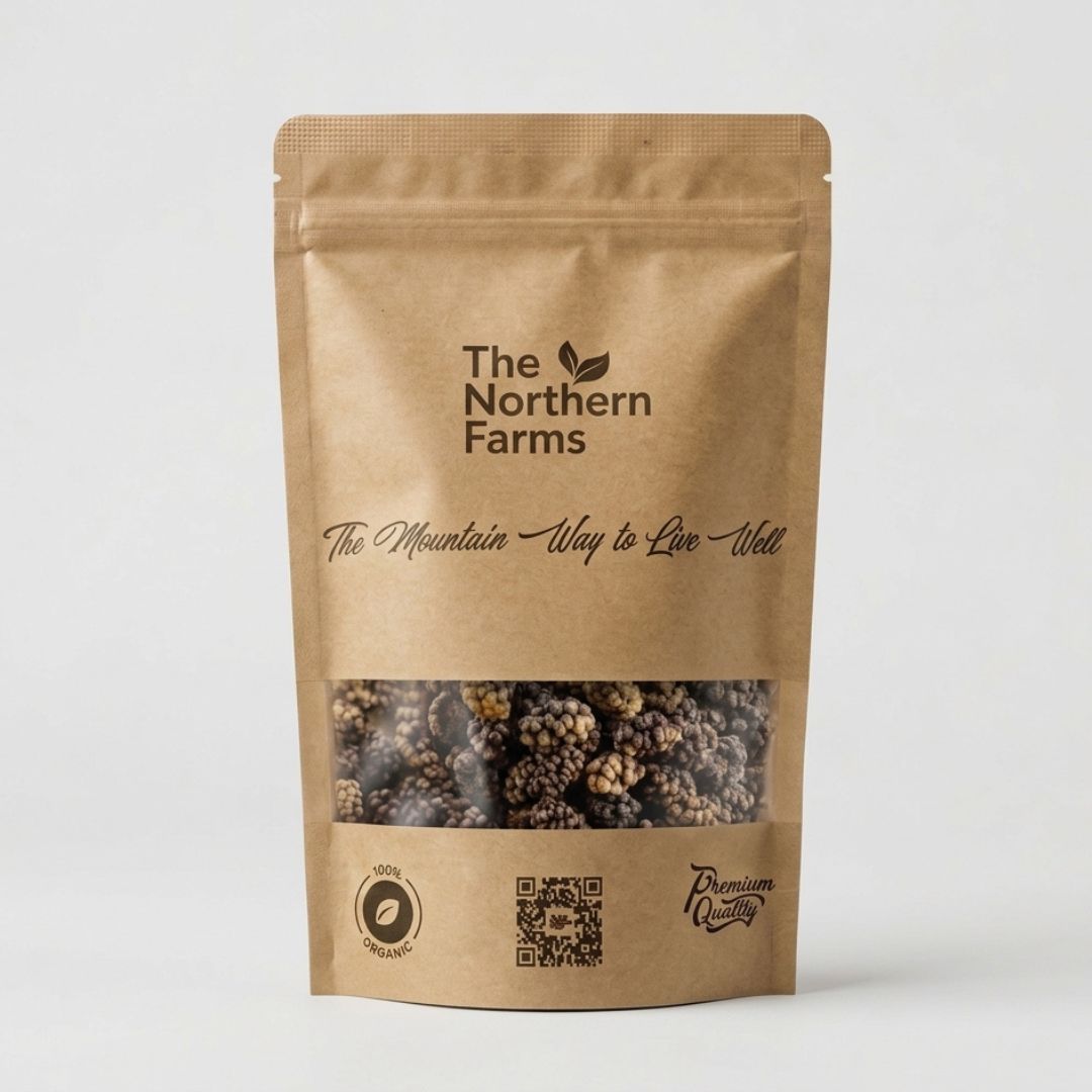 A stand-up kraft paper pouch of The Northern Farms organic black mulberries from Chitral, featuring a clear window that displays the kala shahtoot. The packaging has black printed text and The Northern Farms logo on a clean, light gray background.